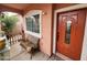 A quaint front porch with a bench and decorative details, creating a cozy and inviting entryway at 21817 W Harding Ave, Wittmann, AZ 85361