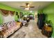 Spacious living room with bright green walls and tile floors and an abundance of natural light at 21817 W Harding Ave, Wittmann, AZ 85361