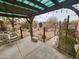 Covered patio area with chairs and view of the landscaped backyard at 21817 W Harding Ave, Wittmann, AZ 85361