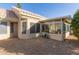 A private backyard with a sunroom, offering a serene outdoor space for relaxing and enjoying the desert views at 22120 N Old Mine Rd, Sun City West, AZ 85375