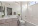 Well-lit bathroom featuring a single sink, a vanity, and a shower-tub combo with white tiling at 22120 N Old Mine Rd, Sun City West, AZ 85375