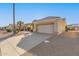 Spacious two-car garage with a long driveway and desert landscaping around the home at 22120 N Old Mine Rd, Sun City West, AZ 85375