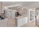 Bright kitchen with white cabinets, a stainless steel refrigerator, and a view of the patio at 22120 N Old Mine Rd, Sun City West, AZ 85375