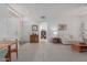 Open-concept living room with tile flooring, ample natural light, and a view of the entryway at 22120 N Old Mine Rd, Sun City West, AZ 85375