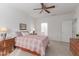 The main bedroom features neutral paint, tiled floors, and a ceiling fan for added comfort at 22120 N Old Mine Rd, Sun City West, AZ 85375