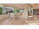 Bright sunroom featuring tile flooring, a dining table, and a relaxing hot tub at 22120 N Old Mine Rd, Sun City West, AZ 85375