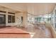 Enclosed sunroom featuring a hot tub, lounge chairs, and tile flooring at 22120 N Old Mine Rd, Sun City West, AZ 85375