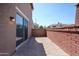 Private back patio with brick pavers and a brick wall, offering a cozy outdoor space at 2260 S Deerfield Ln, Gilbert, AZ 85295