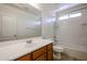 Well-lit bathroom with a vanity, large mirror, and a shower-tub combination with white tile surround at 2260 S Deerfield Ln, Gilbert, AZ 85295