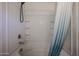 Shower and tub combination with shower curtain and built-in shelving for essentials at 2260 S Deerfield Ln, Gilbert, AZ 85295