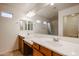 Bathroom with dual sinks, a large mirror, and a walk-in shower at 2260 S Deerfield Ln, Gilbert, AZ 85295