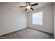 Carpeted bedroom with a ceiling fan and a window allowing ample natural light at 2260 S Deerfield Ln, Gilbert, AZ 85295