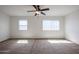 Large bedroom with carpet, ceiling fan, and natural light from two windows at 2260 S Deerfield Ln, Gilbert, AZ 85295