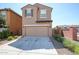 Two-car garage with a long driveway and low-maintenance landscaping at 2260 S Deerfield Ln, Gilbert, AZ 85295