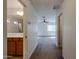 Hallway view to bedrooms and a bathroom with neutral carpet and paint at 2260 S Deerfield Ln, Gilbert, AZ 85295