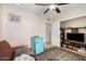 Cozy bedroom with neutral tones, ceiling fan, and vintage-style mini-fridge at 2302 E Sells Dr, Phoenix, AZ 85016