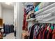 Walk-in closet filled with clothes, pillows, and suitcases at 2302 E Sells Dr, Phoenix, AZ 85016