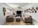 Inviting living room with neutral sofas, ceiling fan, and decorative masks on the wall at 2302 E Sells Dr, Phoenix, AZ 85016