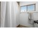 Bright bathroom featuring a shower with a curtain and window at 2302 E Sells Dr, Phoenix, AZ 85016