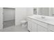 Modern bathroom featuring sleek white cabinets, a toilet, and a large mirror over the vanity at 24182 W Hidalgo Ave, Buckeye, AZ 85326