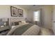 Cozy bedroom featuring a tufted headboard bed, side tables with lamps, neutral walls and a large window at 24182 W Hidalgo Ave, Buckeye, AZ 85326