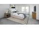 Modern bedroom featuring a white platform bed, clean lines, soft colors, and a cozy rug on the gray floor at 24190 W Hidalgo Ave, Buckeye, AZ 85326