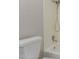 This bathroom has a white toilet next to a tub with a shower head at 2643 E Jerome Ave, Mesa, AZ 85204