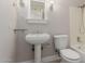 A bathroom with a pedestal sink, modern fixtures, mirror, and a shower/tub combination at 2643 E Jerome Ave, Mesa, AZ 85204