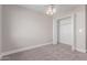 This cozy bedroom features neutral walls, plush carpeting, and a ceiling fan, along with closet space at 2643 E Jerome Ave, Mesa, AZ 85204