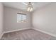 Bedroom with carpet flooring, ceiling fan, and a view of the neighborhood at 2643 E Jerome Ave, Mesa, AZ 85204