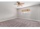 Carpeted bedroom featuring a ceiling fan and plenty of natural light at 2643 E Jerome Ave, Mesa, AZ 85204