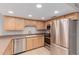 Beautiful kitchen featuring stainless steel appliances, granite countertops, and natural wood cabinets at 2643 E Jerome Ave, Mesa, AZ 85204