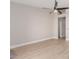 Minimalist living room with a ceiling fan, laminate floors, and neutral walls at 2643 E Jerome Ave, Mesa, AZ 85204