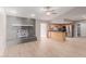 Open-concept living room with brick fireplace, and a seamless flow into the kitchen at 2643 E Jerome Ave, Mesa, AZ 85204