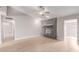 Bright living room featuring a gray brick fireplace and modern ceiling fan at 2643 E Jerome Ave, Mesa, AZ 85204