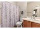 Full bathroom with patterned shower curtain, toilet, and vanity at 28735 N 21St Ave, Phoenix, AZ 85085