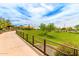 A scenic view of the community park featuring walking paths, a playground, and lush green spaces at 28735 N 21St Ave, Phoenix, AZ 85085