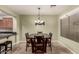 Dining room with a square table, six chairs, pendant lighting, and an adjacent view of the kitchen at 28735 N 21St Ave, Phoenix, AZ 85085