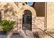 Inviting stone-accented entrance with an iron gate and well-maintained landscaping at 28735 N 21St Ave, Phoenix, AZ 85085