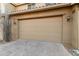 Two car garage with light brown door that complements the home's desert landscape at 28735 N 21St Ave, Phoenix, AZ 85085