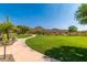 Expansive community green space with mature landscaping and meandering walkways at 28735 N 21St Ave, Phoenix, AZ 85085