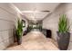 Well-lit hallway with tiled floors, elegant planters, and access to various building amenities at 28735 N 21St Ave, Phoenix, AZ 85085