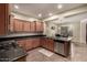 Kitchen with stainless steel appliances, granite countertops, light wood cabinets and an adjacent dining space at 28735 N 21St Ave, Phoenix, AZ 85085