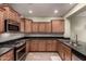 Kitchen featuring stainless steel appliances, granite counters, subway tile backsplash and light wood cabinets at 28735 N 21St Ave, Phoenix, AZ 85085