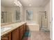 Bright main bathroom featuring double sinks, soaking tub, and a glass-enclosed shower at 28735 N 21St Ave, Phoenix, AZ 85085