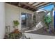 Cozy back patio with iron furniture, potted plants, and shaded trellis at 3133 W Christy Dr, Phoenix, AZ 85029