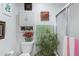 Cozy bathroom featuring white fixtures, decorative plants, and a shower, offering a serene and refreshing space at 3133 W Christy Dr, Phoenix, AZ 85029