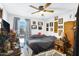 Inviting bedroom with a ceiling fan, a comfortable bed, and a window with natural light at 3133 W Christy Dr, Phoenix, AZ 85029