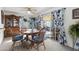 Bright dining area with a large wooden table, seating for six, and sliding doors leading to the outdoor area at 3133 W Christy Dr, Phoenix, AZ 85029