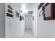 Hallway with white walls and tiled floors, decorated with uplifting wall art and leading to multiple rooms at 3133 W Christy Dr, Phoenix, AZ 85029